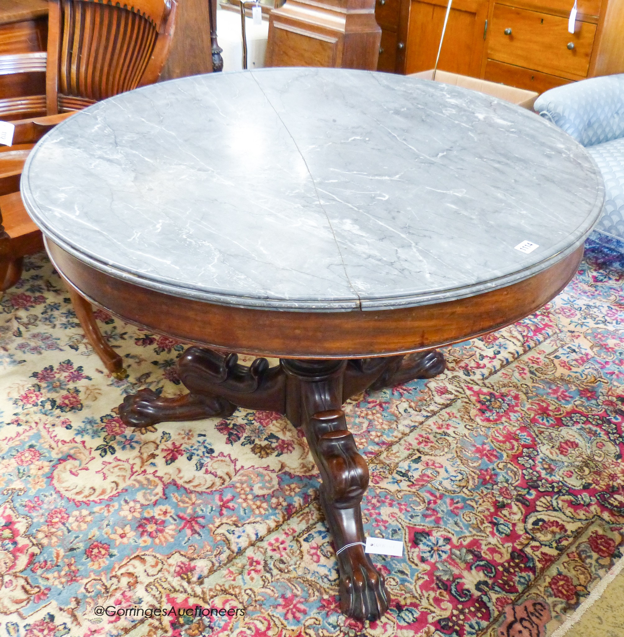 An early 19th century French mahogany circular marble topped centre table